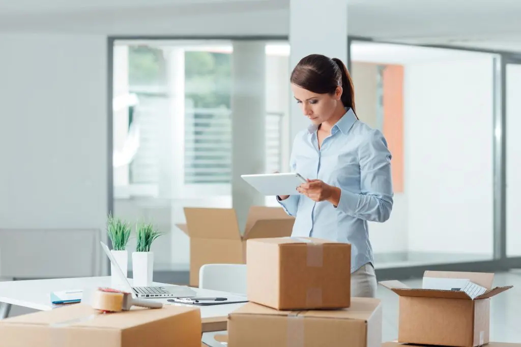 woman unpacking boxes scaled 1